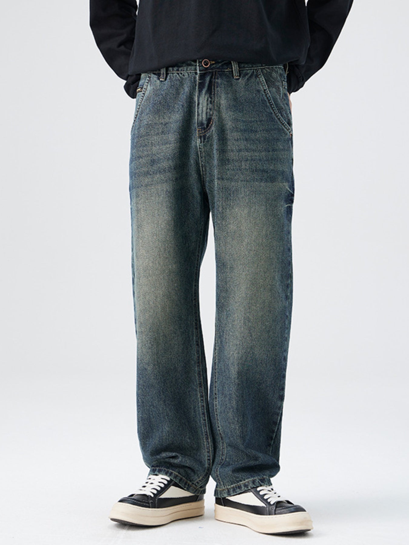 Men's relaxed fit vintage wash denim jeans with distressed details.