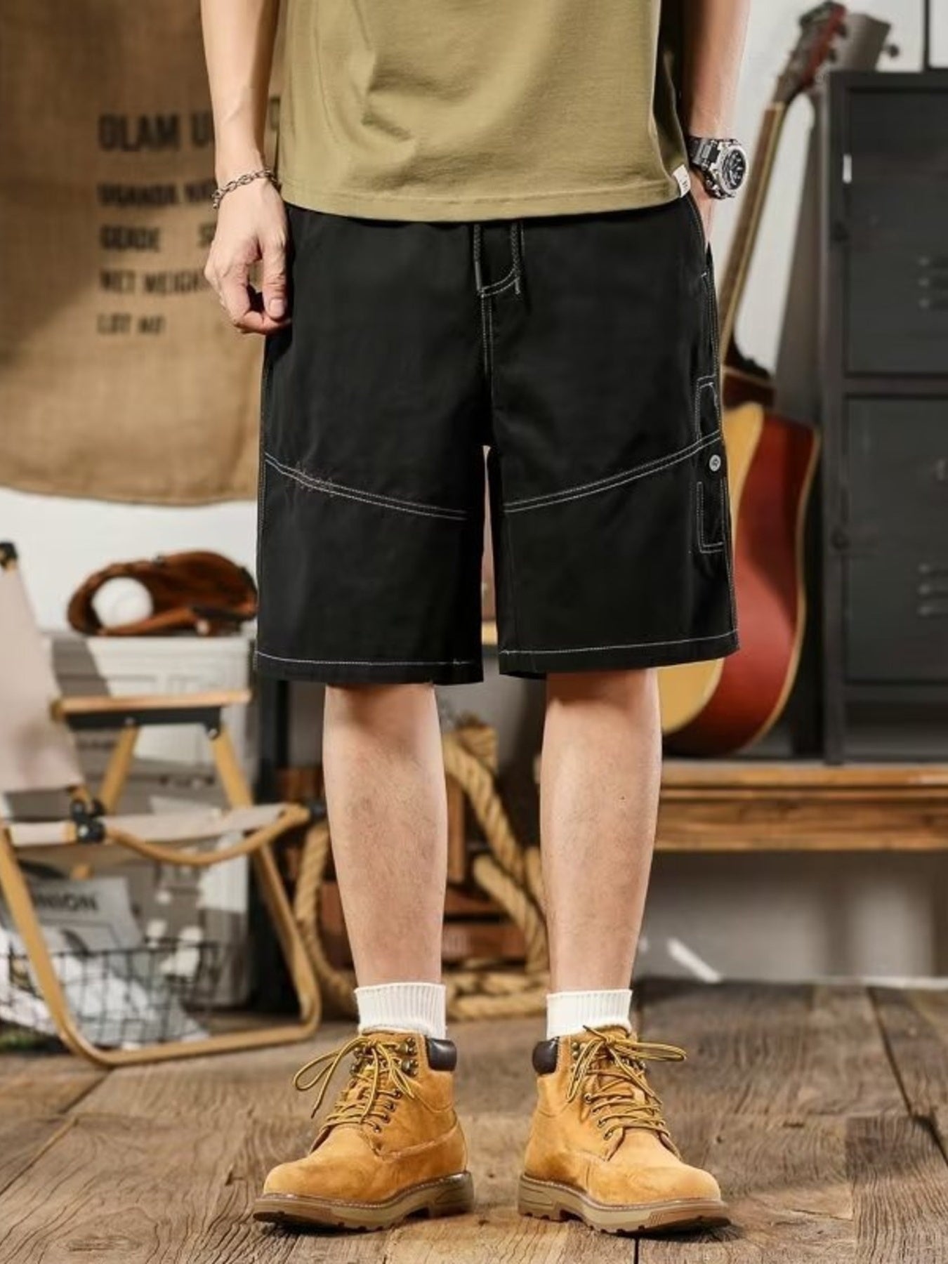 Men's black relaxed fit drawstring shorts with contrast stitching and cargo pocket.