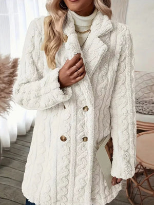 White faux shearling double-breasted coat with cable knit texture and button details.