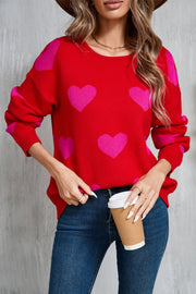 Red acrylic sweater with pink intarsia hearts, crew neck, long sleeves.