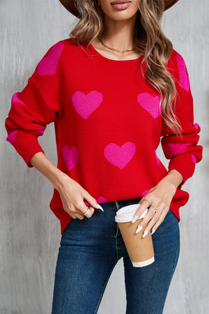 Red acrylic sweater with pink intarsia hearts, crew neck, long sleeves.