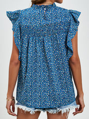Smocked yoke ruffle sleeve floral blouse in dark blue with mock neck and button back.