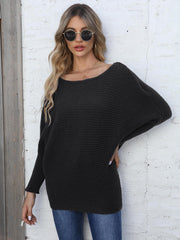 Black ribbed dolman knit sweater with off-the-shoulder neckline.