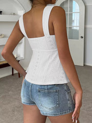White eyelet cami with square neckline and drawstring detail, styled with denim shorts.