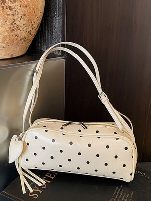 Ivory polka dot shoulder bag with heart charm and fringe detail
