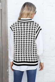 Houndstooth knit vest with V-neck and striped trim, layered over a white shirt.