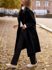 Black oversized wool-blend cocoon coat with wide lapels and a relaxed fit.