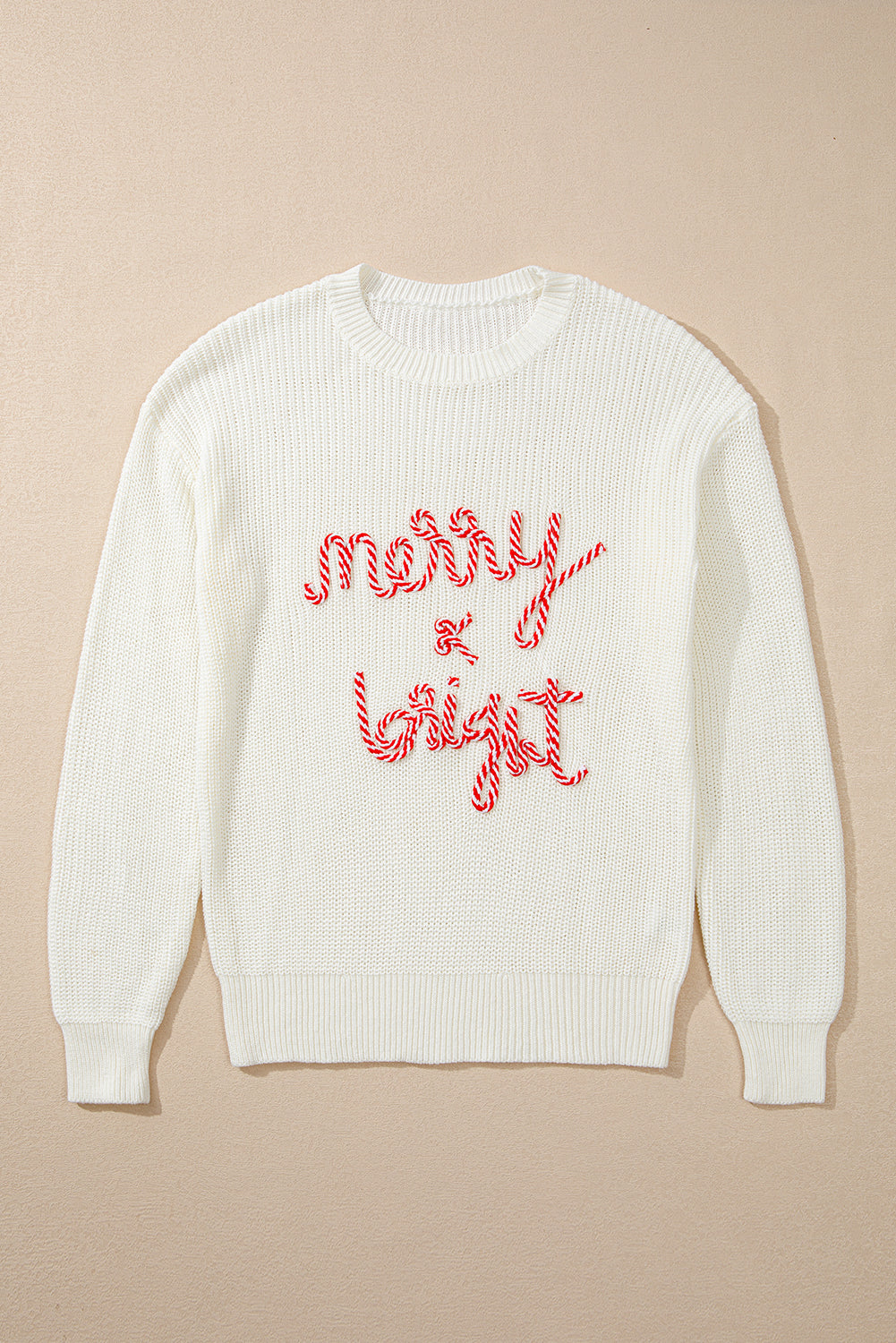 Ivory knit sweater with red candy cane script saying Merry & Bright.