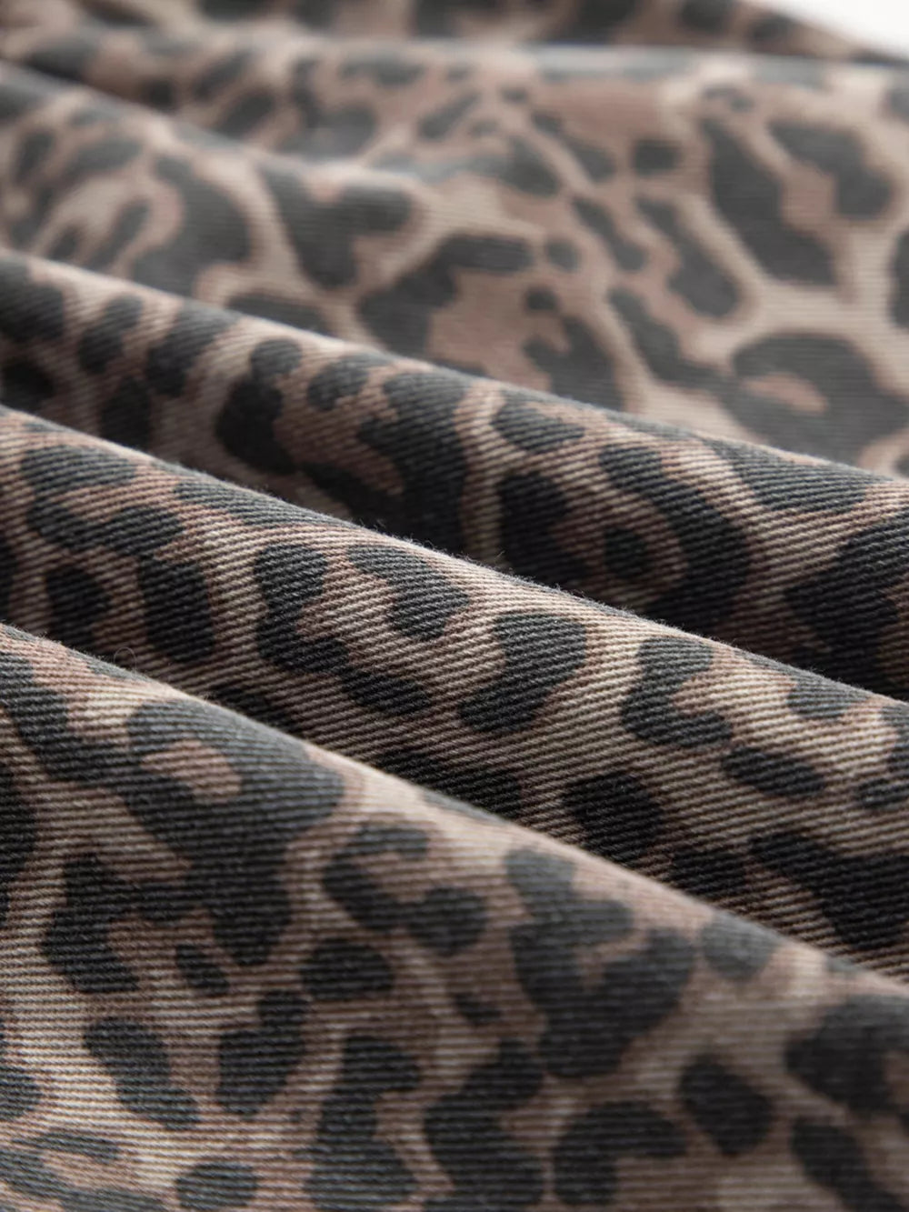 Leopard print V-neck denim top with a textured fabric detail