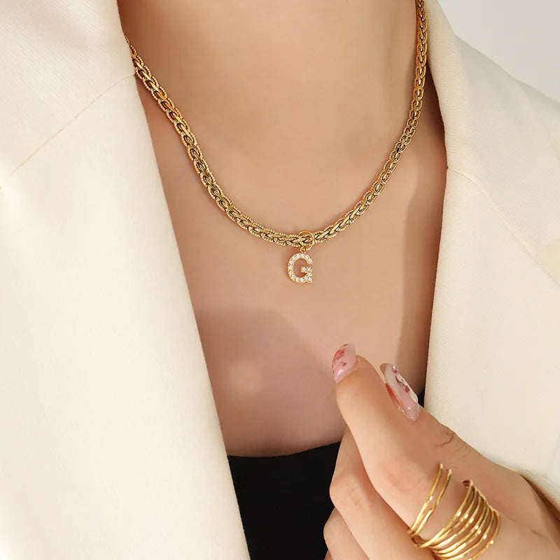 Gold chain necklace with a zircon-set initial G pendant