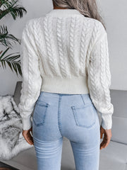 White cable knit cropped mock neck sweater with ribbed hem and cuffs.