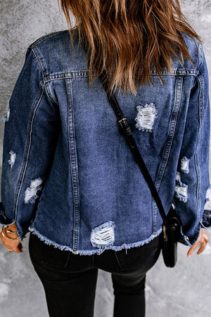 Denim trucker jacket with distressed details and frayed hem.