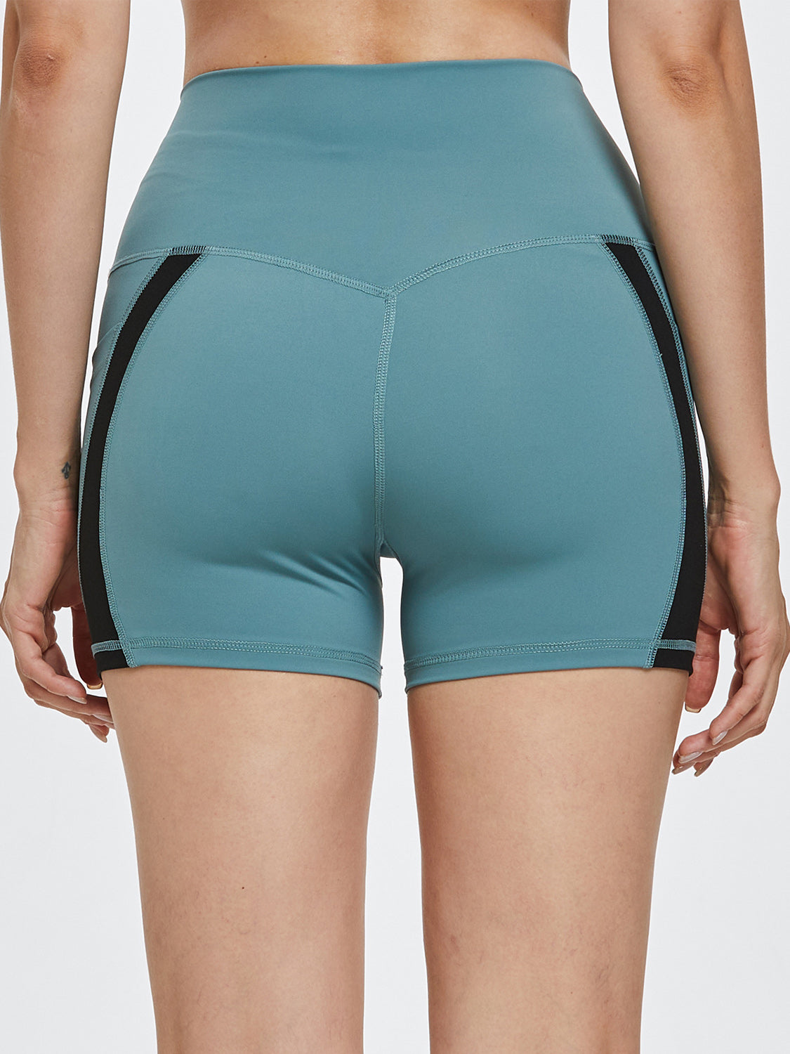 Turquoise activewear shorts with black side stripe detail and V-shaped seam.