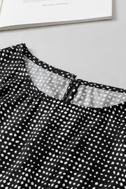 Black dotted blouse with a square neckline and keyhole detail