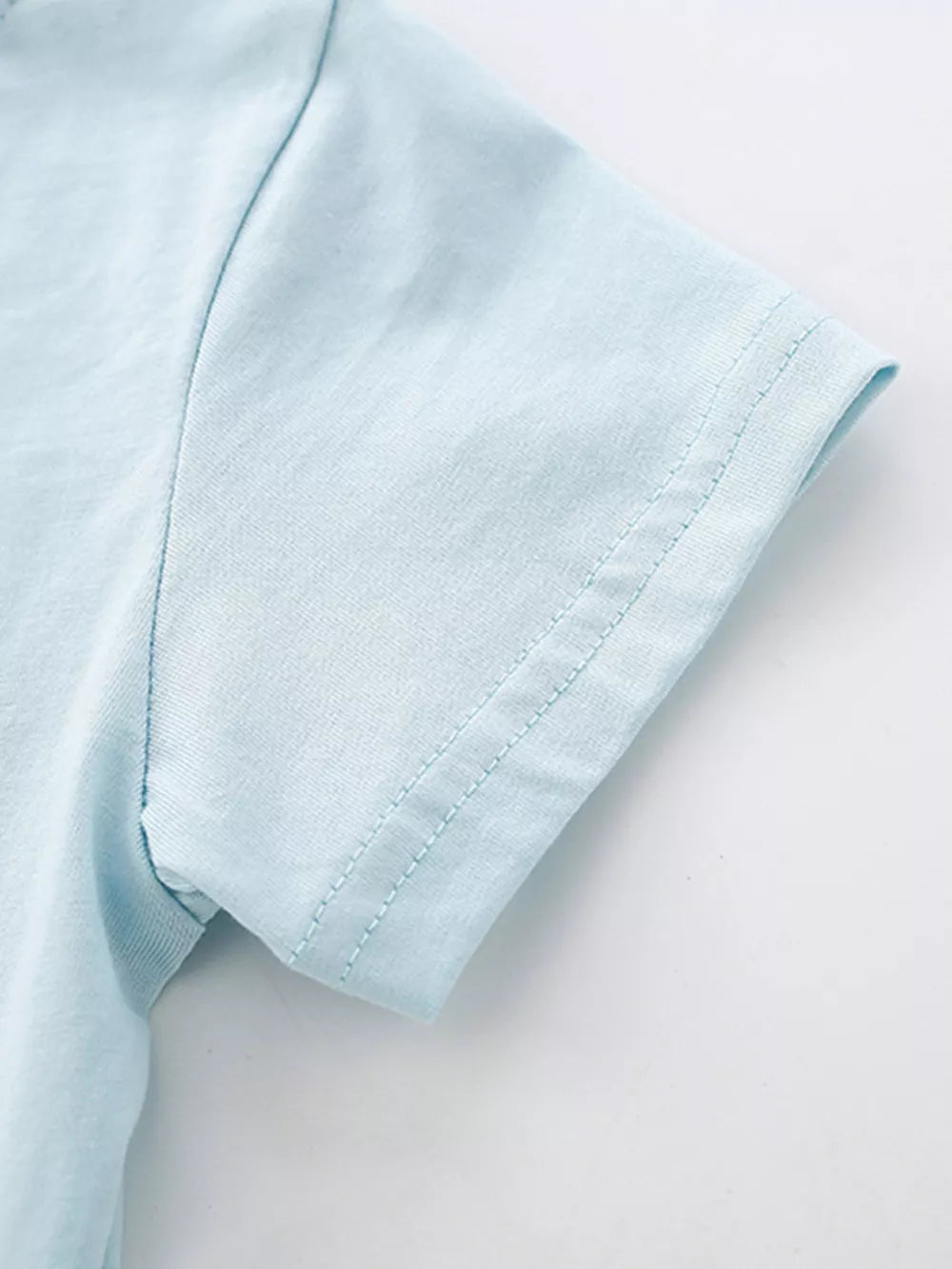 Baby blue cotton tee sleeve detail with double stitching.