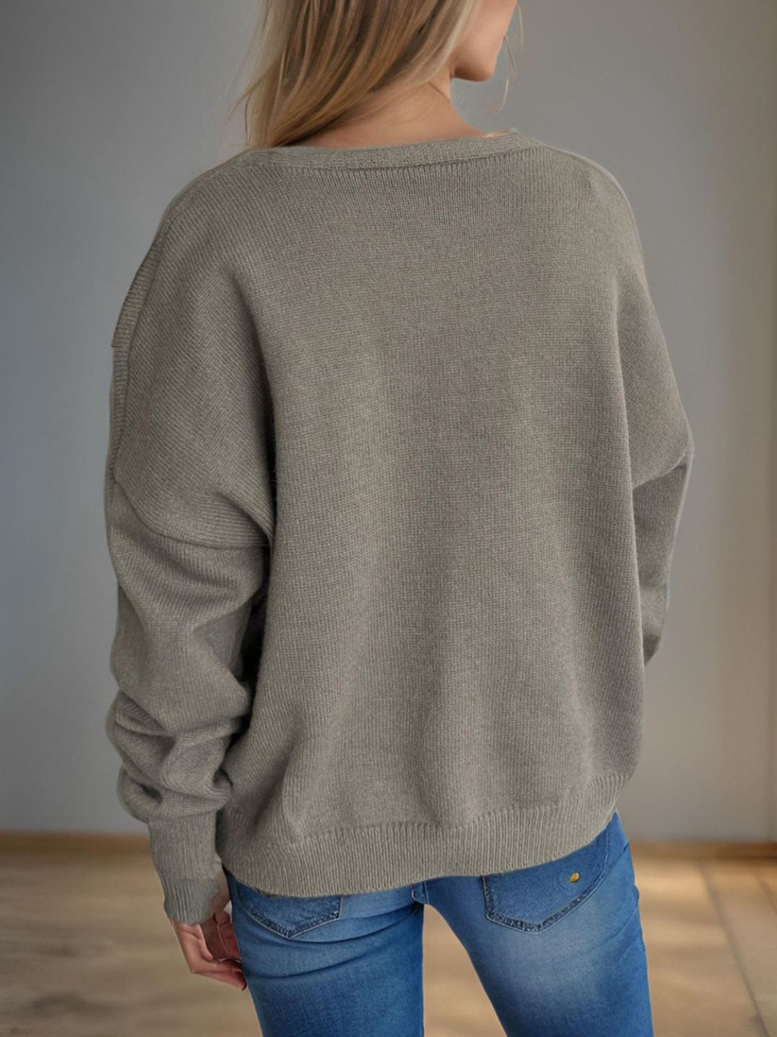 Gray oversized knit cardigan with crew neck and button front, acrylic material