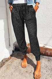 Charcoal leopard print drawstring trousers with cuffed ankles.