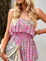 Boho romper with smocked waist and paisley print in pink, featuring a strapless neckline.