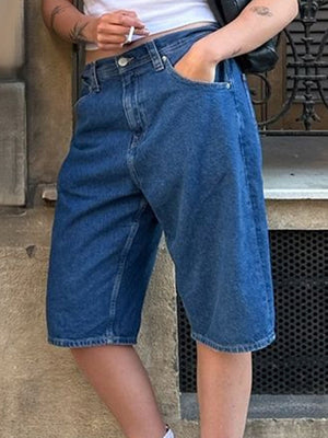 Culotte-cut denim bermuda shorts in Dusty Blue with a buttoned fly and casual styling.