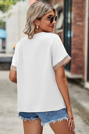 White V-neck blouse with lace trim on short sleeves