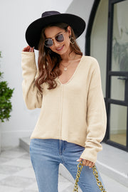 Caramel fluffy knit sweater with plunging neckline and long sleeves.