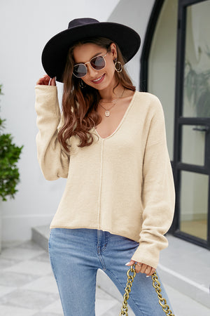Caramel fluffy knit sweater with plunging neckline and long sleeves.