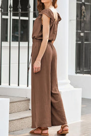 Tan textured drawstring palazzo jumpsuit with ruffle sleeves and wide legs.