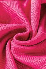 Textured loungewear fabric in hot pink with a subtle geometric pattern.