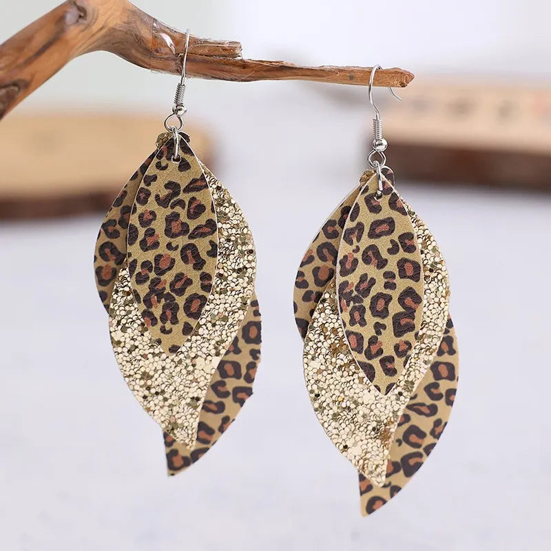 Leopard print layered drop earrings with gold glitter accents.