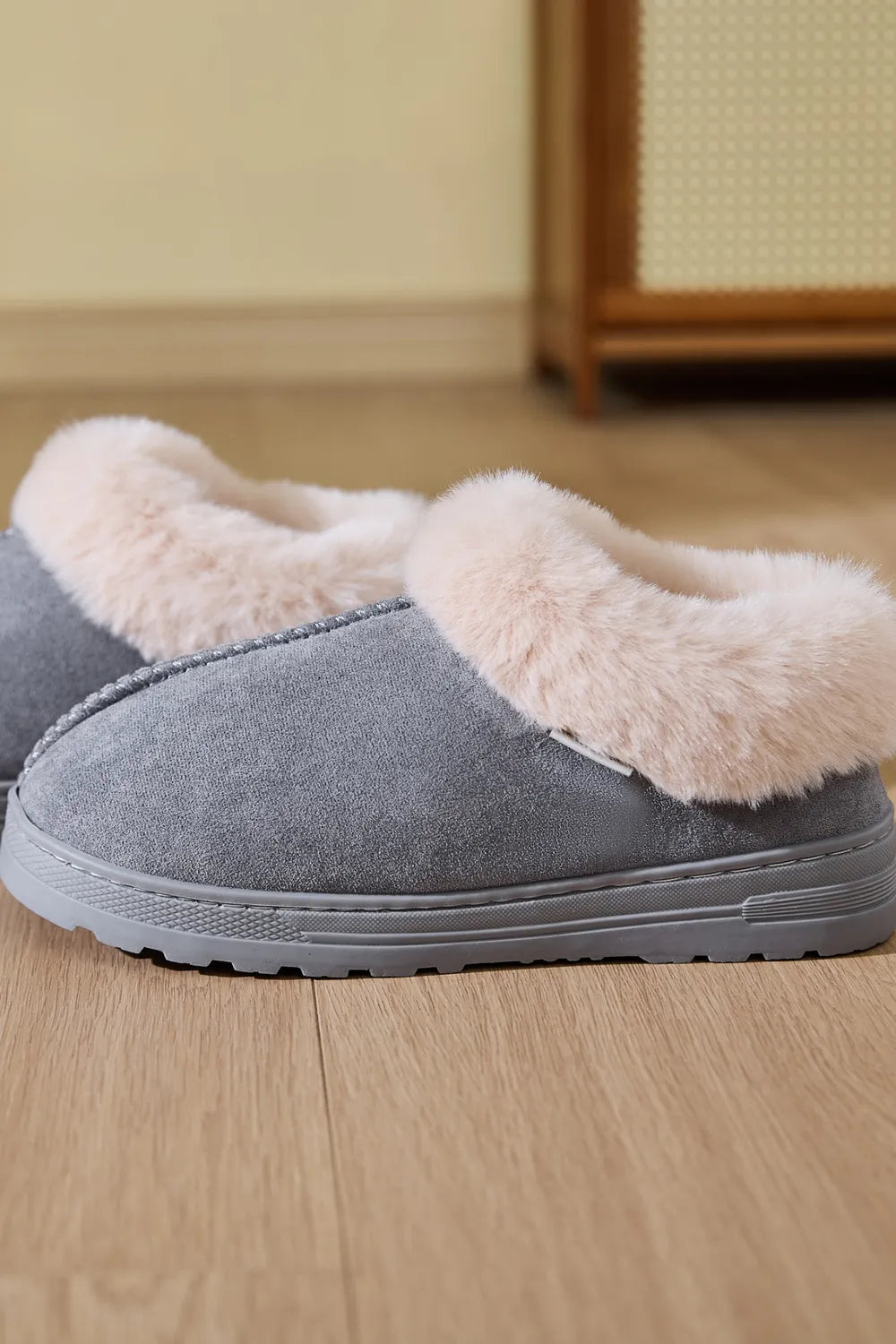 Gray suede house slippers with plush faux fur trim.