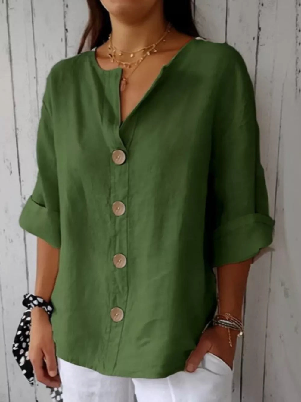 Dark green button-down shirt with relaxed fit and wooden buttons.