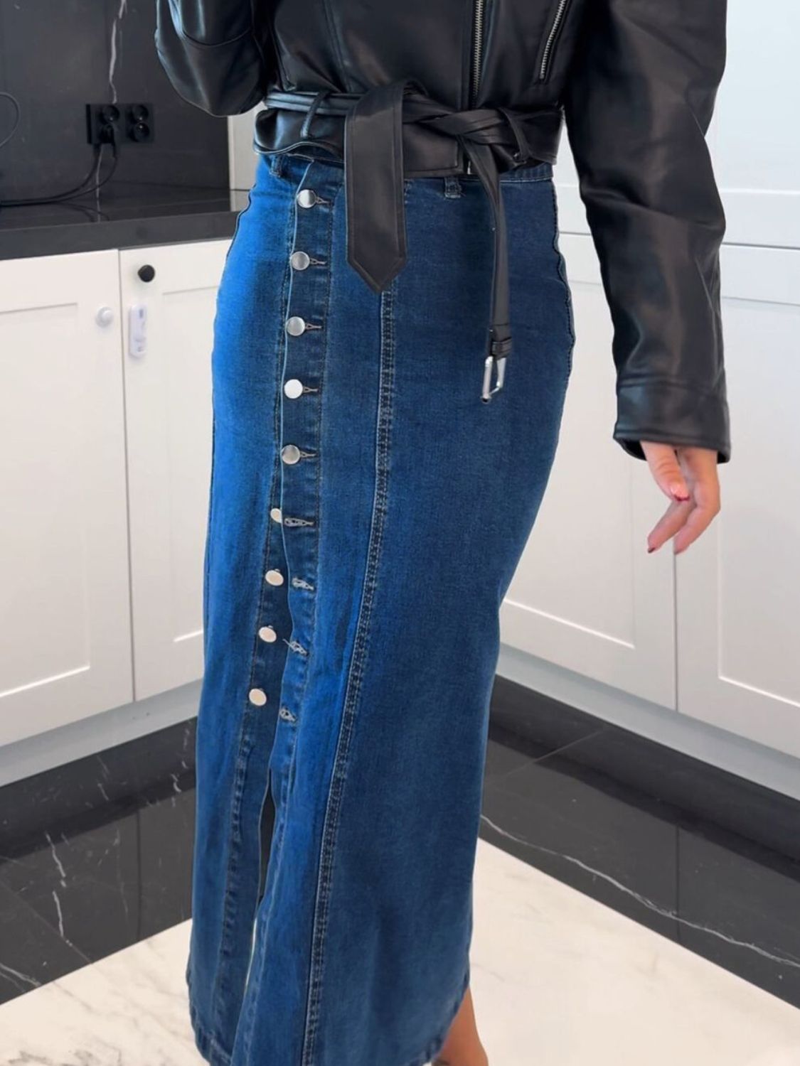 Button-front denim midi skirt in medium wash with a slit and silver buttons.
