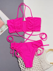 Hot pink ruched strappy bikini set with tie sides and halter neck top.