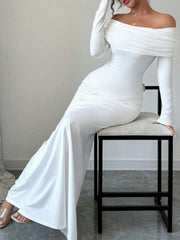 White off-shoulder bodycon maxi dress with draped neckline and long sleeves.