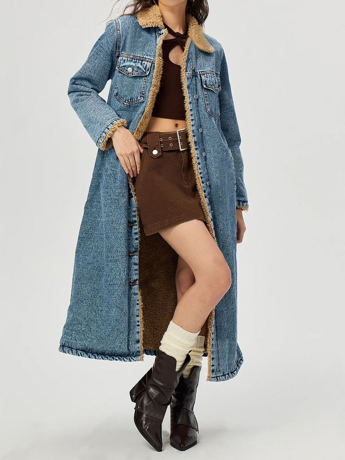 Denim maxi coat in medium blue with shearling trim and lining, buttoned front.