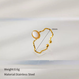 Wavy gold-plated ring with oval cream natural stone, adjustable stainless steel band