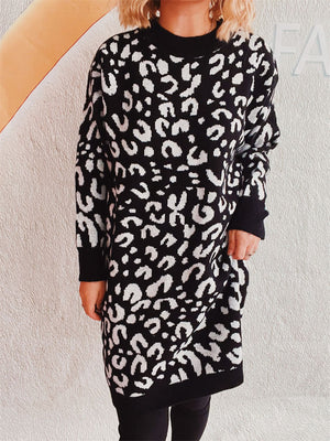 Black leopard print knit mini dress with long sleeves and mock neck.