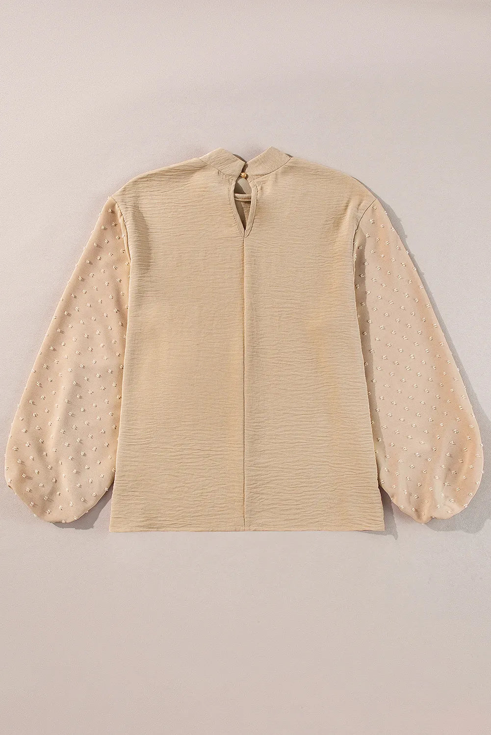 Tan textured blouson top with Swiss dot sheer balloon sleeves and mock neck.
