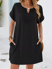 Black lace-trimmed V-neck pocket dress with short sleeves and cuffed hems.