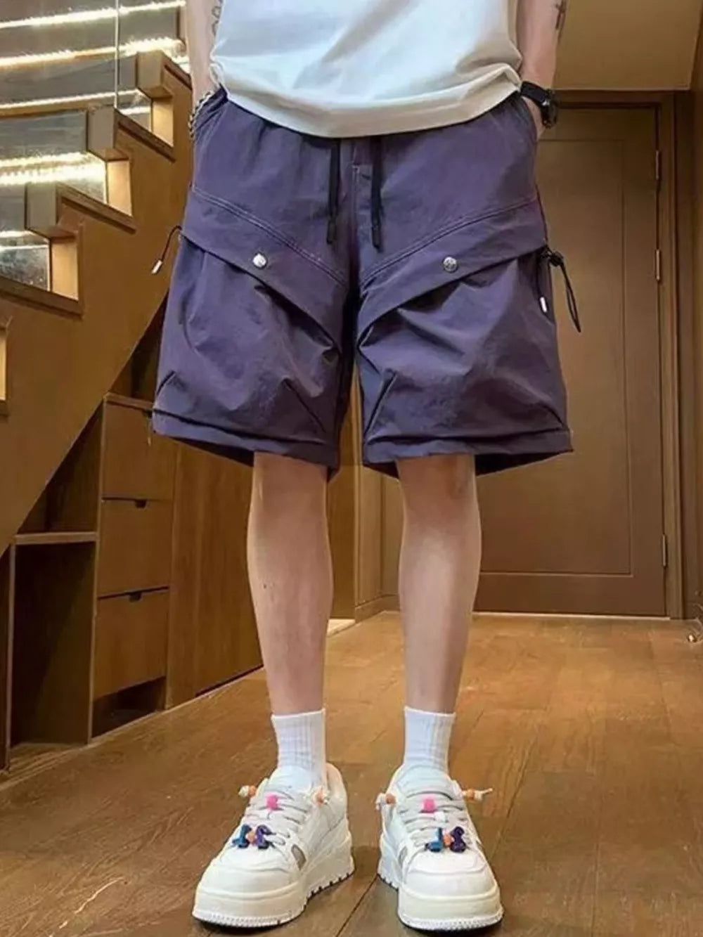 Mauve lightweight cargo shorts with drawstring and flap pockets, worn by a man.