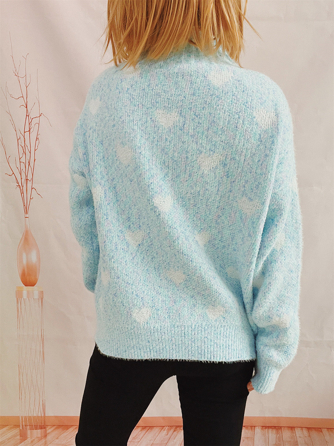 Mint blue acrylic turtleneck sweater with a white heart motif and textured knit.