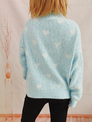 Mint blue acrylic turtleneck sweater with a white heart motif and textured knit.