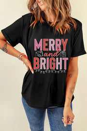 Black cotton tee with rolled sleeves and "Merry and Bright" graphic featuring holiday icons.