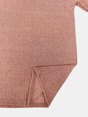 Ribbed knit pullover in burnt coral with side slit detail.