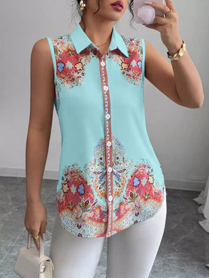 Sleeveless collared shirt in blue with vibrant paisley print and button front.