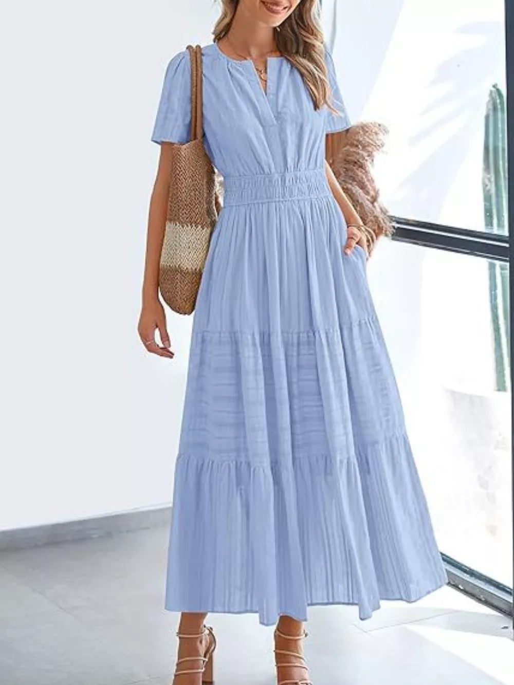 Light blue ruched V-neck tiered midi dress with short sleeves and pockets.
