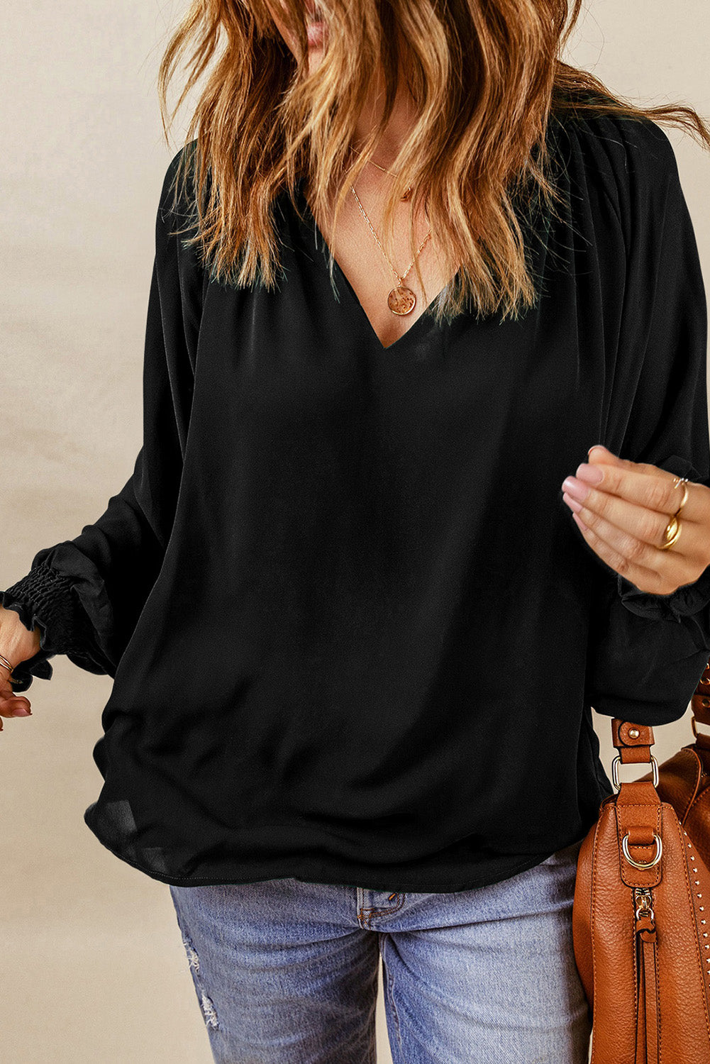 Black ruched cuff voluminous sleeve blouse with V-neck.