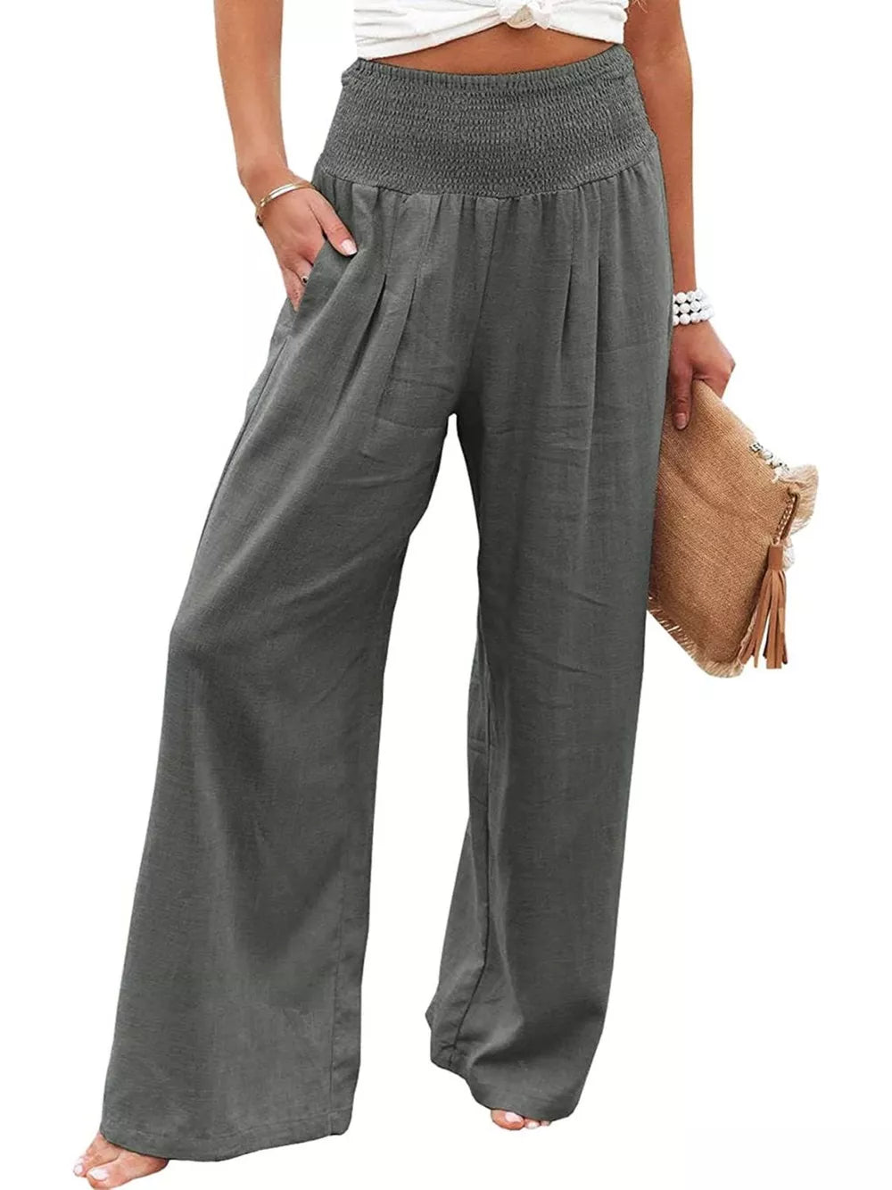 Dark Gray smocked maternity pants with wide legs and pockets, styled casually.
