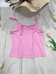 Pink cami top with scoop neck and thin straps.