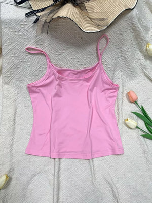 Pink cami top with scoop neck and thin straps.